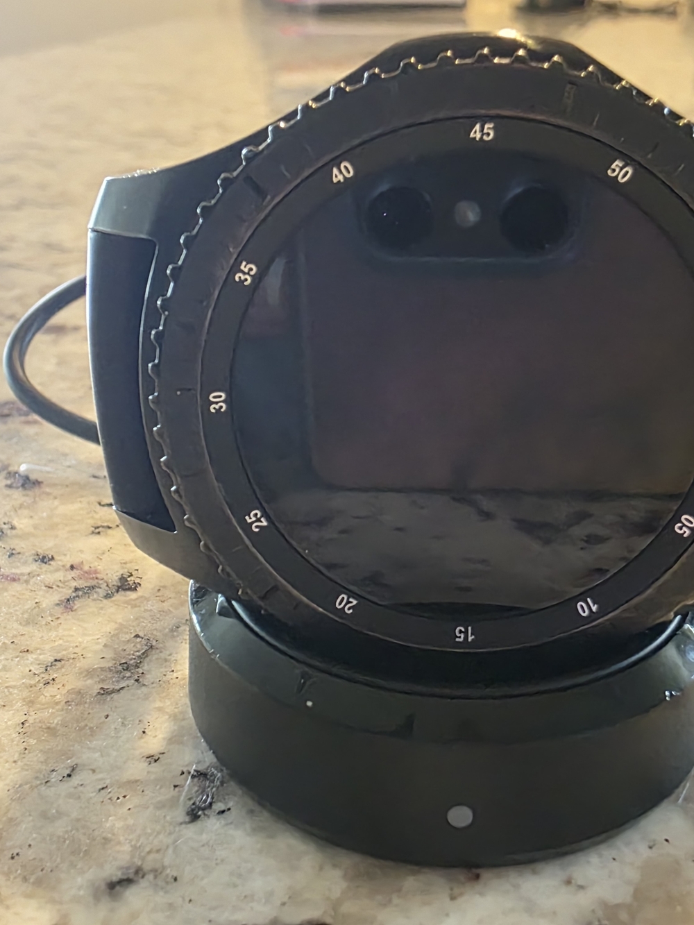 Black Round Samsung Smartwatch on Charging Dock - Picture 2 of 4